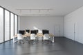 Business room interior with armchairs and computers on concrete floor, city view Royalty Free Stock Photo