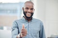 Business is running smoothly here. a handsome young businessman standing alone in his office and making a thumbs up