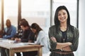 Business is running smoothly today. Portrait of a cheerful businesswoman posing with her arms folded in a modern office Royalty Free Stock Photo