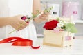 Business, sale and floristry concept - close up of florist woman holding bunch at flower shop. Soft shades of fresh flowers