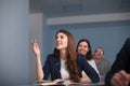 2016.01.17 Business school training in the Samara State University. Lady student is raising her hand in class for an