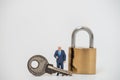 Business and Security Concept. Businessman miniature figure people standing and show thumb up with silver key and gold master key