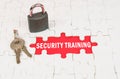On puzzles there is a lock and keys, on a red surface there is an inscription - Security training