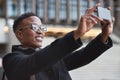 Business, selfie and smile of black man in city taking pictures for happy memory outdoors. Profile picture, street and