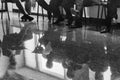 Business seminar. Black and white photography. Shallow depth of field. Background. People in the reflection of the floor