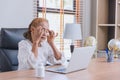 Business senior Asian Elder woman headache migraine sick from working looking at computer screen long time Royalty Free Stock Photo