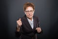 Business senior lady holding fists like fighting Royalty Free Stock Photo