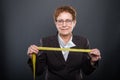 Business senior lady holding measuring tape