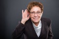 Business senior lady showing cant hear you gesture Royalty Free Stock Photo