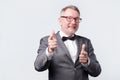 Business senior man pointing at you wearing suit and bow tie Royalty Free Stock Photo