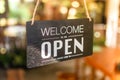 A business sign that says open on cafe or restaurant hang on door at entrance Royalty Free Stock Photo