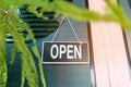 A business sign that says open on cafe or restaurant hang on door at entrance. Vintage color tone styl Royalty Free Stock Photo