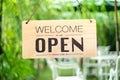 A business sign that says open on cafe or restaurant hang on door at entrance. Royalty Free Stock Photo