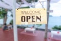 A business sign that says open on cafe or restaurant hang on door at entrance. Royalty Free Stock Photo