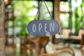 A business sign that says open on cafe or restaurant hang on door at entrance. Royalty Free Stock Photo