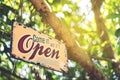 A business sign that says open on cafe or restaurant hang on door at entrance. Vintage color tone style Royalty Free Stock Photo