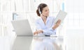 Business smiling woman or a clerk working at her office desk wit Royalty Free Stock Photo