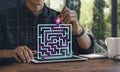 Business solution or problems solving concept. Man is drawing a route path through the maze on tablet computer Royalty Free Stock Photo