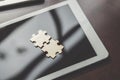 Business solutions, Two piece jigsaw put on tablet Royalty Free Stock Photo