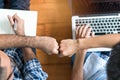 Business start up partners teamwork. Top view of Designer and programmer doing fists bump after work is done and build project