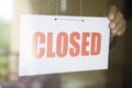 Business store owner turning closed sign at shop doorway Royalty Free Stock Photo