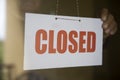 Business store owner turning closed sign at shop doorway Royalty Free Stock Photo