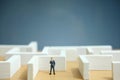 Business strategy conceptual photo - Miniature of businessman looking for solution on a labyrinth maze Royalty Free Stock Photo