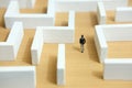 Business strategy conceptual photo - Miniature of businessman looking for solution on a labyrinth maze Royalty Free Stock Photo