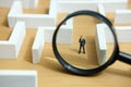 Business strategy conceptual photo - Miniature of businessman looking for solution on a labyrinth maze Royalty Free Stock Photo