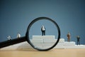 Business strategy conceptual photo - Miniature of businessman stands on a podium