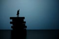 Business strategy conceptual photo - Silhouette of miniature businessman pointing upside above wooden staircase