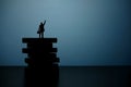 Business strategy conceptual photo - Silhouette of miniature businessman pointing upside above wooden staircase