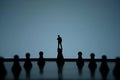 Silhouette of miniature of thinking businessman standing on castle pawn Royalty Free Stock Photo