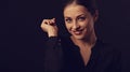 Business strong thinking woman with natural makeup looking with hand near the face arms in black t-shirt on dark shadow black Royalty Free Stock Photo