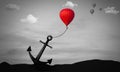 Business Struggle and Challenge. Metaphor and Figure of Speech Concept.Heavy Anchor Holding Back Air Balloon. Surrealism Scene