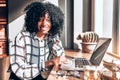 Business or study concept.Beautiful african american woman working in a beautiful cozy office near the window looking at camera