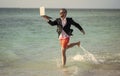 business success. Beach productivity for the director businessman. Businessman director running at the beach. director Royalty Free Stock Photo