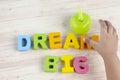DREAM BIG  word on wooden desk over blue background Royalty Free Stock Photo