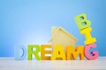 DREAM BIG  word on wooden desk over blue background Royalty Free Stock Photo