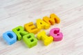 DREAM BIG word on wooden desk blue background Royalty Free Stock Photo