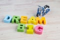 DREAM BIG word on wooden desk blue background Royalty Free Stock Photo
