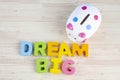 DREAM BIG  word on wooden desk over blue background Royalty Free Stock Photo