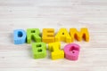 DREAM BIG  word on wooden desk over blue background Royalty Free Stock Photo