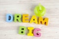 DREAM BIG  word on wooden desk over blue background Royalty Free Stock Photo