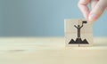 Business success and goal achievement concept. Market leader.  Businessman hold wooden cubes with winer and leader icon on beautif Royalty Free Stock Photo