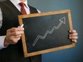 Business success. The manager holds a sign with an upward arrow drawn. Royalty Free Stock Photo