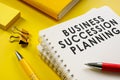 Business succession planning documents on yellow surface. Royalty Free Stock Photo