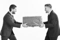 Business succsses. Two businessmen with aggressive expression pull box in opposite Royalty Free Stock Photo