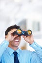 Business tactician. Portrait of attractive young business man using binoculars. Royalty Free Stock Photo