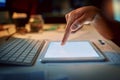 Business at the tap of an icon. an unrecognizable man using a digital tablet during a late night at work. Royalty Free Stock Photo